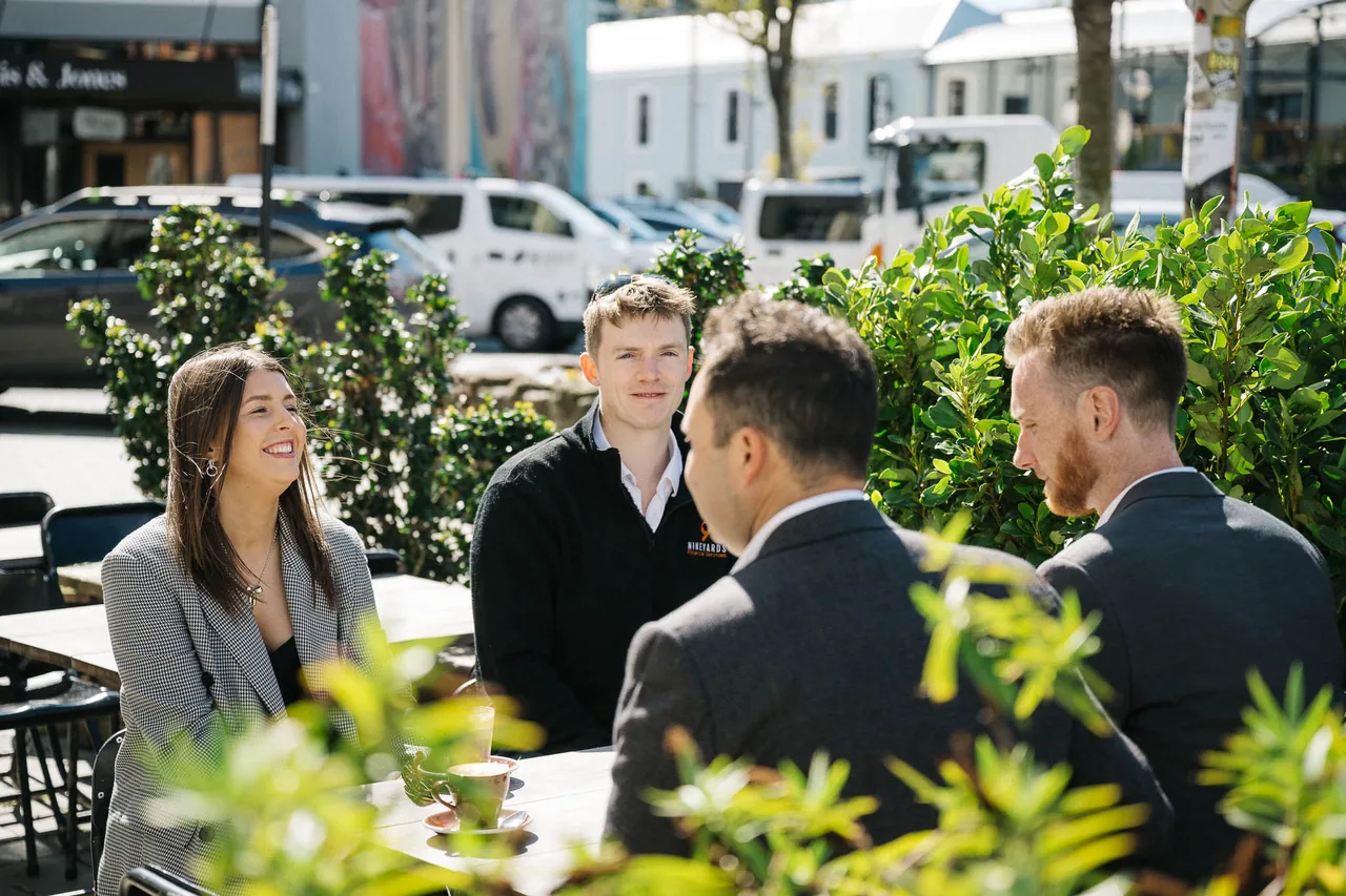 Ella Shanks and Robbie Staniford talking with Jonathan Liong and Mitch van der Weert over coffee